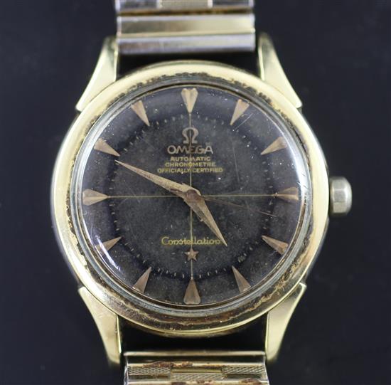 A gentlemans 1960s gold plated and steel Omega Constellation automatic wrist watch with black pie pan dial,